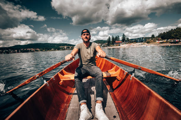 istock Young man rowing on a lake in Germany 1262986457