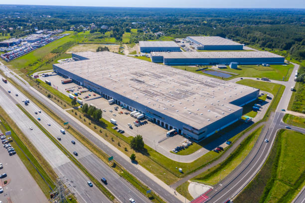 istock Aerial Shot of Industrial Loading Area where Many Trucks Are Unloading Merchandise. 1262988377