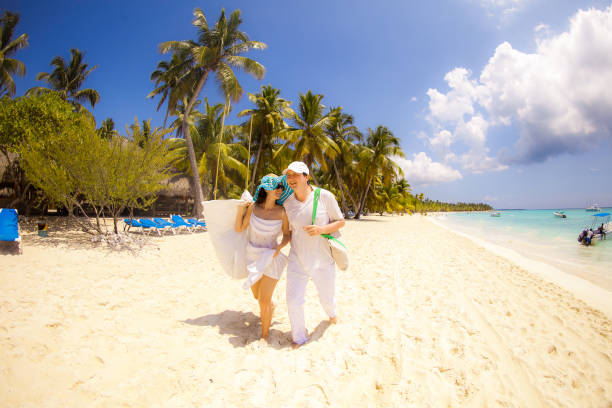 istock tourists walk through empty sandy sea beach. 1262990894