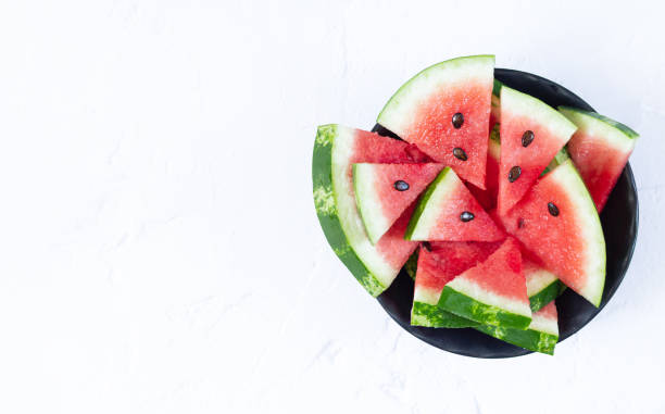 istock Fresh sliced watermelon in bowl top view with copy space 1262990947
