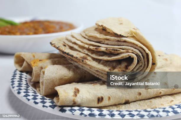 Premium Photo  Tawa chapati roti served in plate isolated on table top  view of indian and pakistani spicy food