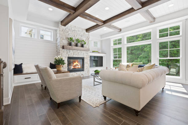 Family room with a wall full of windows Hardwood flooring and wood beams on the coffered ceiling interior stock pictures, royalty-free photos & images