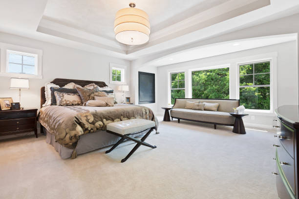 istock Spacious master bedroom with room enough for a large couch and foot stool 1262993334