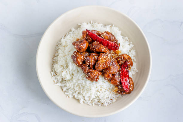 general tso's chicken on top of white rice directly above horizontal photo - chicken general tso food imagens e fotografias de stock