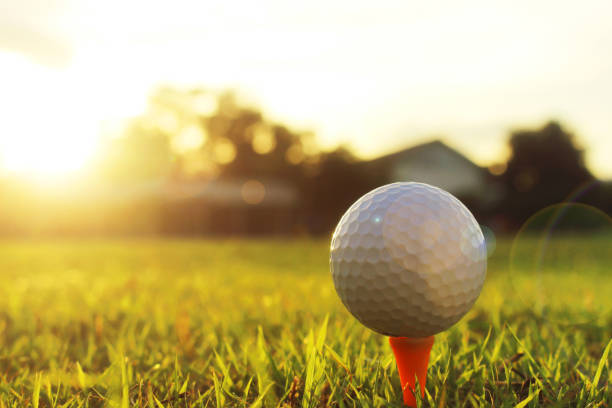 istock golf ball on tee in a beautiful golf course with morning sunshine. 1262995147