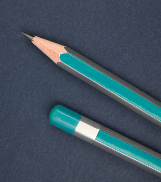 istock Two blue color wood pencil crayon placed on a deep blue color note paper diary 1262997150