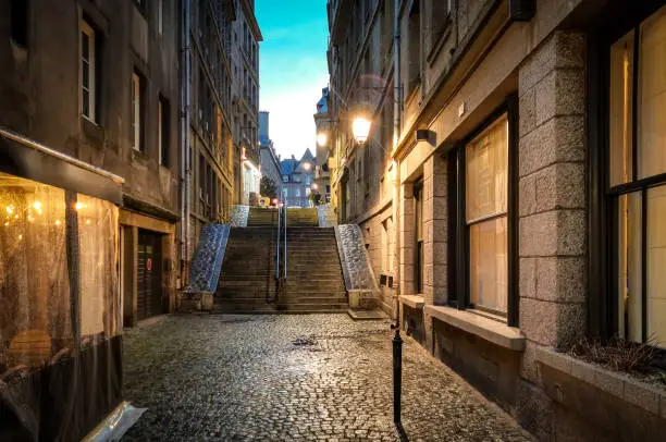 Narrow streets of St Malo, France at night after it has rained.