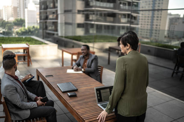 istock Businesswoman doing a presentation outdoors to his colleagues 1262999984