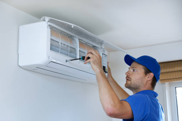 istock hvac services - technician installing air conditioner on the wall at home 1263004810