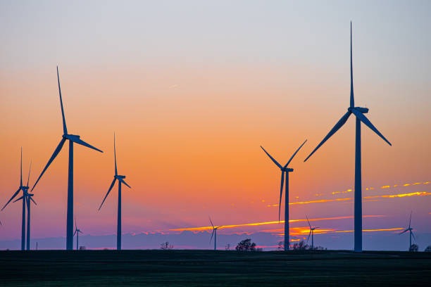 Kansas Wind Farm with agriculture at sunset Kansas Wind Farm with agriculture at sunset in Pratt, KS, United States public utility stock pictures, royalty-free photos & images