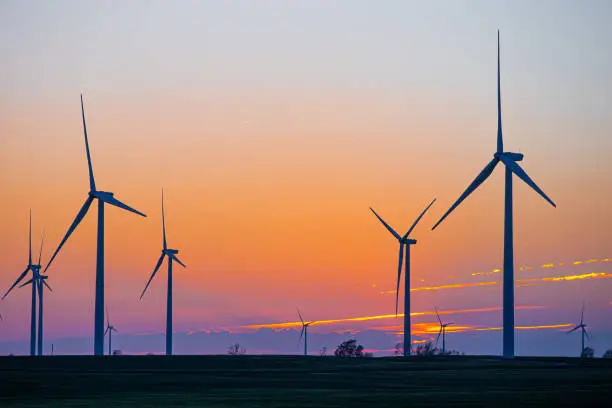 Kansas Wind Farm with agriculture at sunset in Pratt, KS, United States