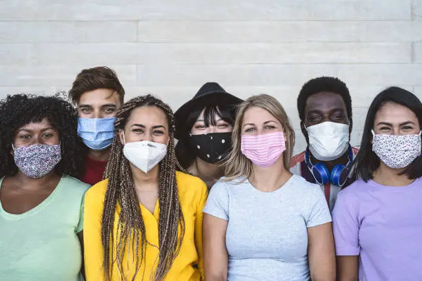 Photo of Group young people wearing face mask for preventing corona virus outbreak - Millennial friends with different age and culture portrait -  Coronavirus disease and youth multi ethnic concept