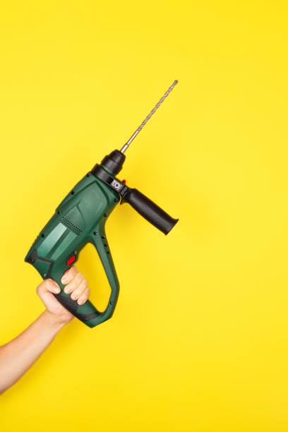 istock Green Puncher in the hands of a builder. 1263008300