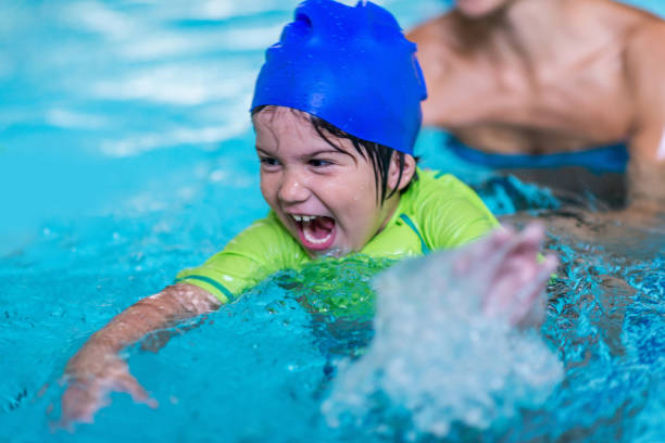 istock Excited little boy in a swimming pool 1263008568