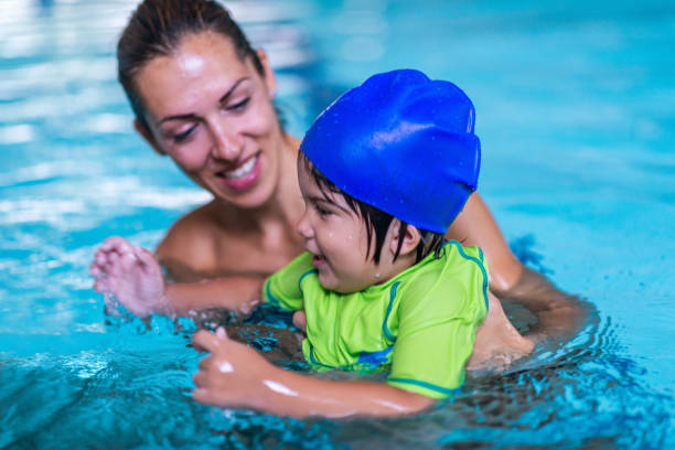 istock Little child having a swimming lesson 1263008597