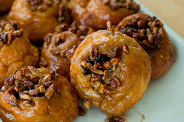 istock Cinnamon rolls or sticky buns. Breakfast breads: cinnamon rolls & sticky buns served w/ cream cheese, butter, jelly & jams. Classic American or French style breakfast or brunch. Variety of breakfast breads & pastries. 1263010390