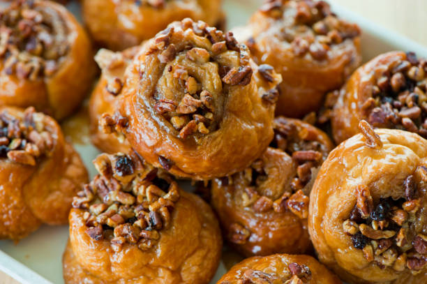 istock Cinnamon rolls or sticky buns. Breakfast breads: cinnamon rolls & sticky buns served w/ cream cheese, butter, jelly & jams. Classic American or French style breakfast or brunch. Variety of breakfast breads & pastries. 1263010424
