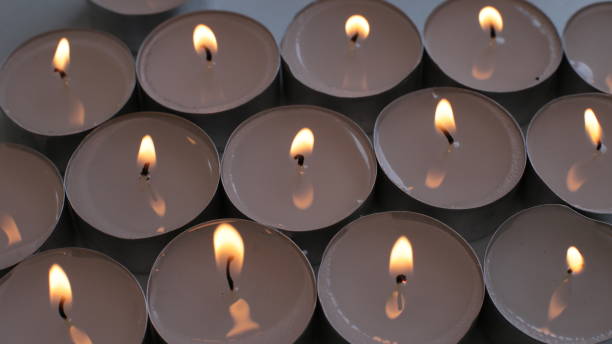 istock Burning small white candle festive background 1263012169