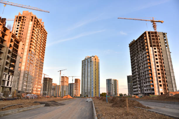 istock View on the large construction site with tower cranes and buildings on sunset background. 1263013504