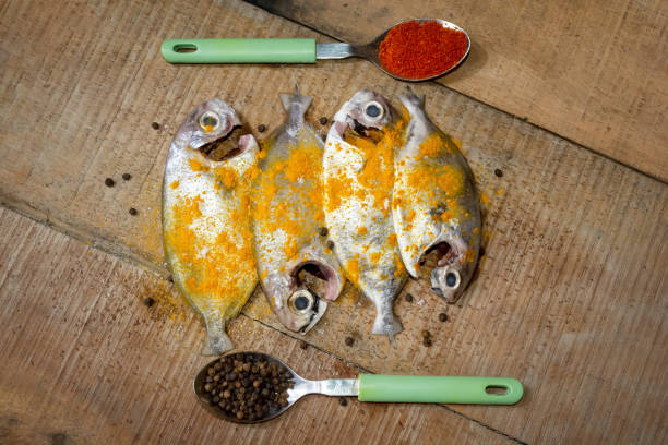Fresh cleaned Japanese butterfish on wooden background.
