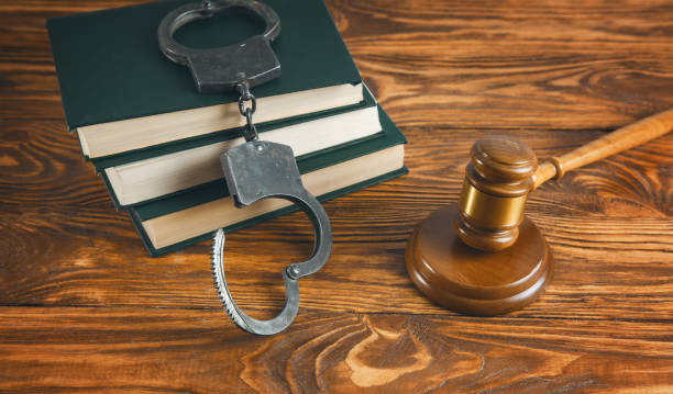 istock judge and handcuffs on book 1263016054