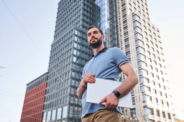 istock Serene young man with notebook in street 1263016978