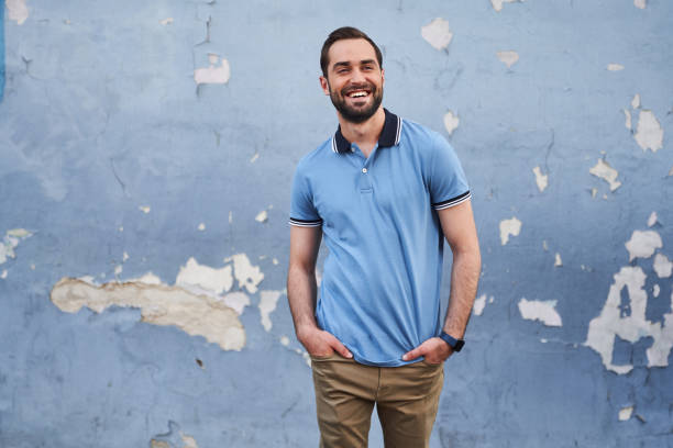 istock Happy young casual man on blue wall background 1263017075