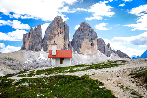 A woman is admiring the landscape in Seiser Alm, Dolomites. Alpe di Siusi with Langkofel mountain group in the background.