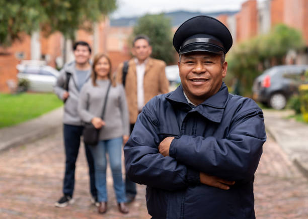 istock Happy security guard working at a gated community protecting people 1263019770