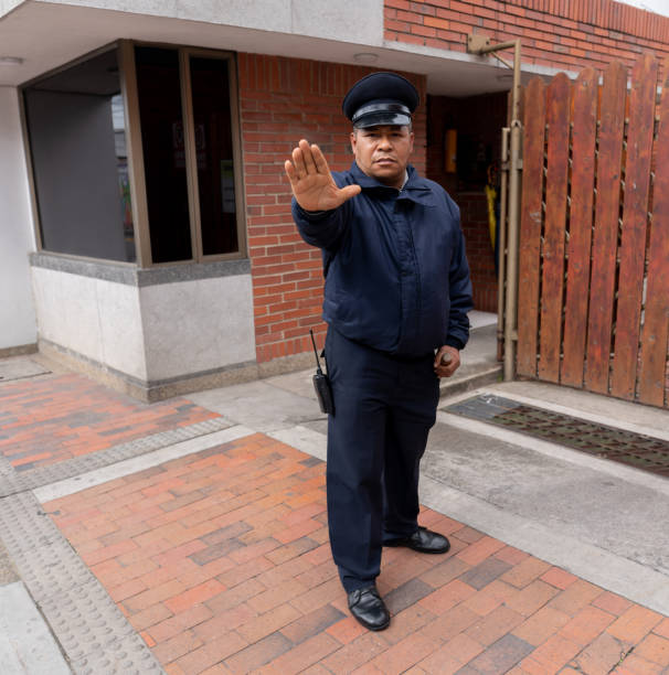 Security guard working at a gated community keeping people from trespassing - safety concepts