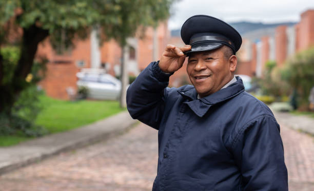 Portrait of happy security guard working at a gated neighborhood and smiling - safety concepts