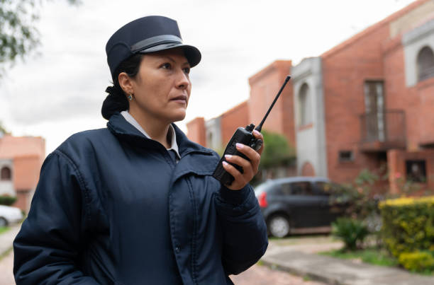 istock Security guard working at a gated community and talking on the radio 1263019935