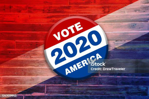 Vivid Red White Blue Vote 2020 America Button Pin On Wood Background Featuring Tilted Gradient Over Faded Stripes Painted Over Wooden Boards Used As Invitation Card Sign Poster Board Stock Photo - Download Image Now