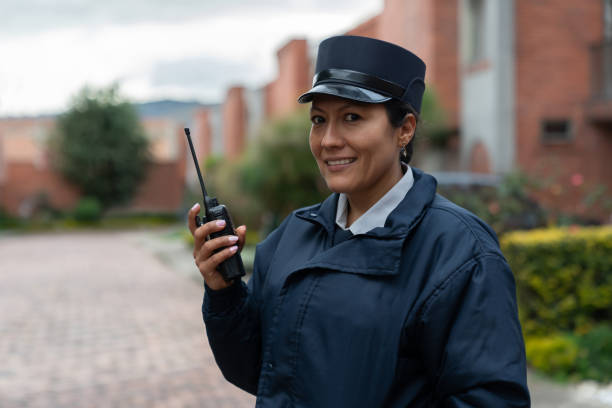 istock Female security guard at work talking on the radio 1263019958
