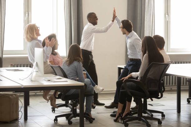 istock African American executive with colleague giving high five during briefing 1263022861