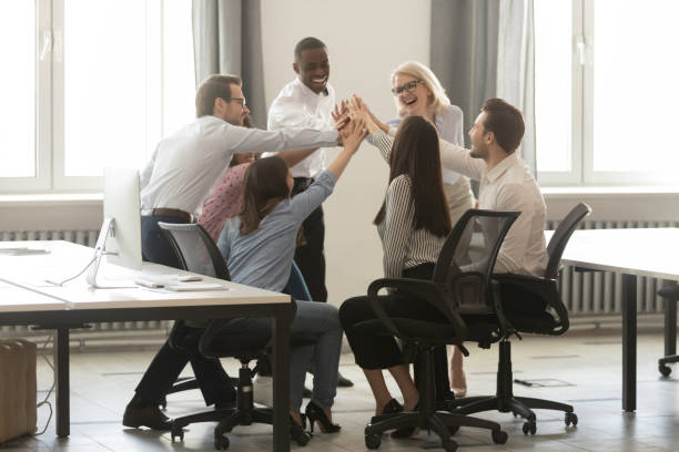 istock Happy diverse employees giving high five at business briefing 1263022865