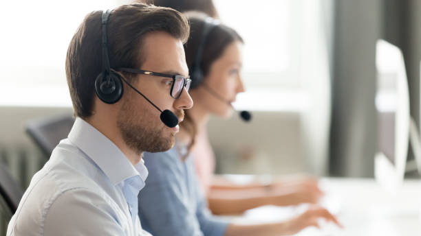 confident call center operator agent in headset consulting client online - call center imagens e fotografias de stock