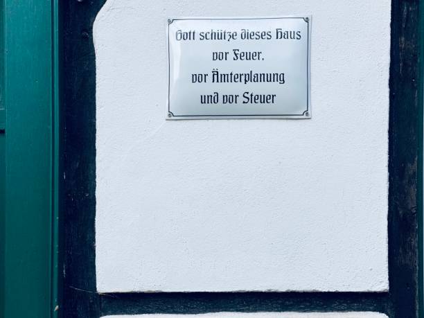 istock Sign on half-timbered house wall, german text: God protect this house... 1263022904