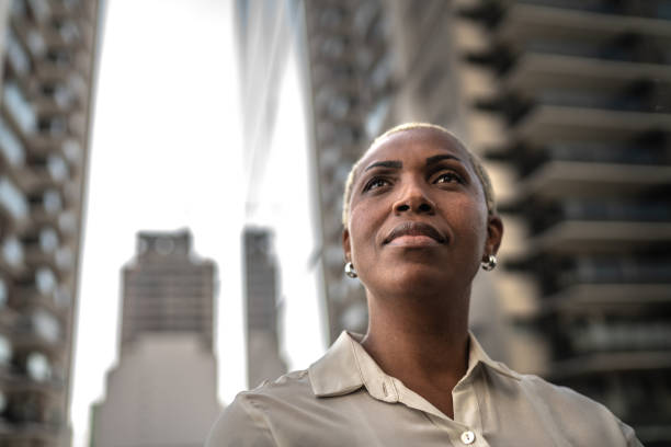 Businesswoman loking away outdoors Businesswoman loking away outdoors dedication stock pictures, royalty-free photos & images