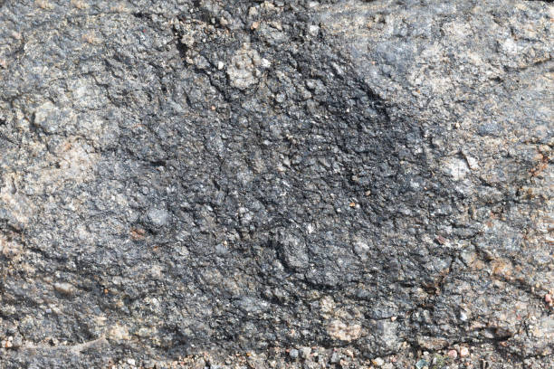istock Natural stony background in grey color with copy space. Materials for designers, empty wall made of rock, banner 1263026393