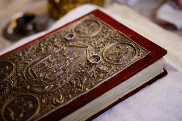 istock An old bible with two white gold rings on it 1263027389
