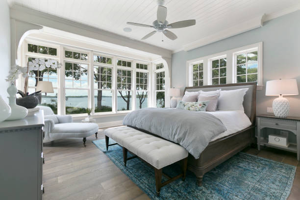 Beautiful bedroom windows and ceiling fan Nice chaise lounge chair in new home luxury mattress pictures stock pictures, royalty-free photos & images