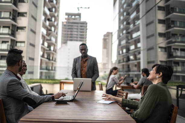 istock Senior businessman doing a presentation outdoors to his colleagues 1263032713