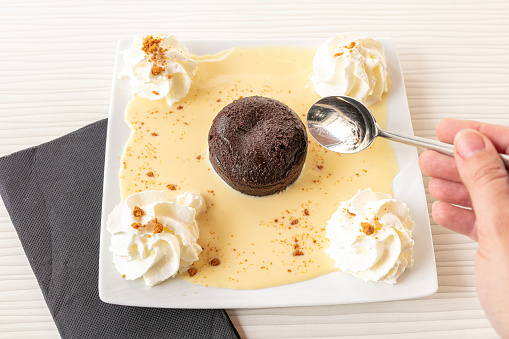 Chocolate fondant with custard and whipped cream