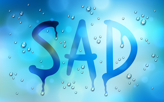 Sad word drawn on a window over blurred background and water rain drops, vector realistic illustration, bad depressing weather theme.