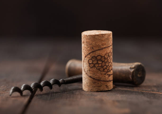 istock Wine cork with vintage corkscrew on wooden background. 1263037982