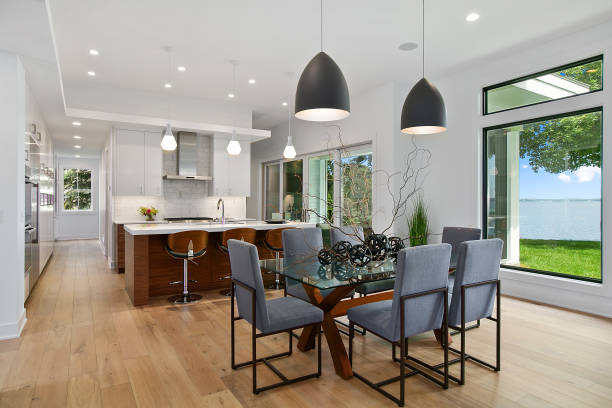 Modern styles in this home with pendant lighting and recessed lighting Kitchen and dining area in million dollar modern home light fixture stock pictures, royalty-free photos & images