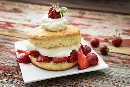 Strawberry shortcake on a rustic wood background.