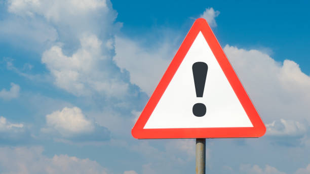 istock Exclamation mark on road sign background sky with clouds, warning, danger, attention 1263041825