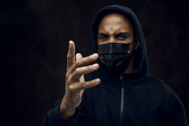 No more racism Afroamerican man wearing hoodie and black facial mask. Anti-racism concept. i cant breathe photos stock pictures, royalty-free photos & images